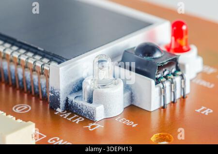 Close-up view of electronic components on a circuit board with LEDs and an IR sensor Stock Photo