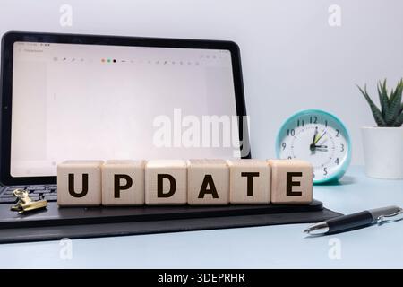 Closeup of word on dice on wooden desk background concept - update Stock Photo
