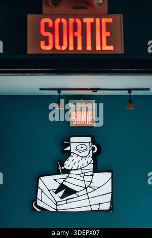 Saint-Gedeon, Canada - August 18, 2025: Brewery interior with mascot logo artwork and illuminated exit sign at a local microbrewery Stock Photo
