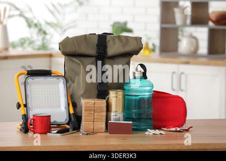 Emergency backpack with necessities on table in kitchen Stock Photo