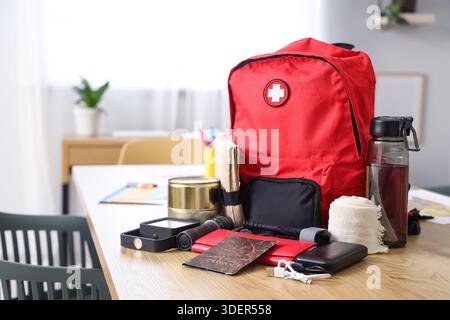 Emergency backpack with necessities on table in classroom Stock Photo