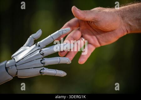 Robot and human hands in futuristic concept. Robotic hands with human engineering. Robot hands on automation machine. Human hands with robot Stock Photo
