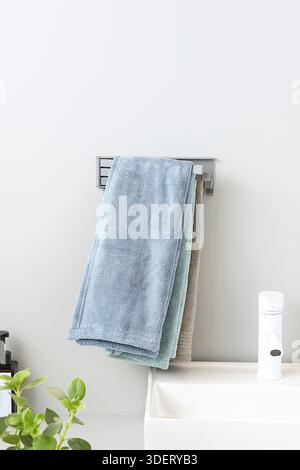 Folded Grey Swivel Towel Rack in Minimalist Bathroom Interior Mockup Stock Photo