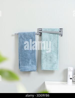 Grey Plastic Swivel Towel Rail with Blue and Green Towels Bathroom Mockup Stock Photo