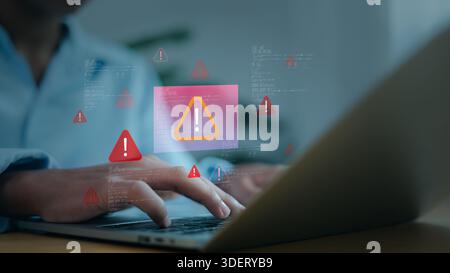 Man hands using laptop with digital red warning icons, system error, virus attack and cybersecurity concept. Professional programmer troubleshooting s Stock Photo