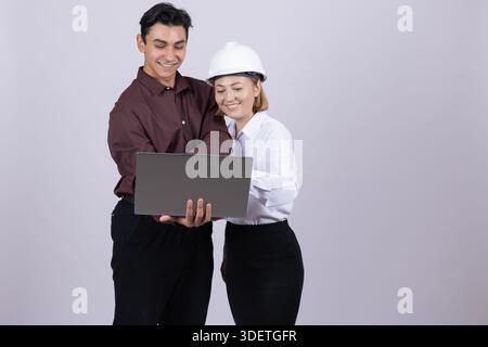 Young man and woman looking at laptop Stock Photo