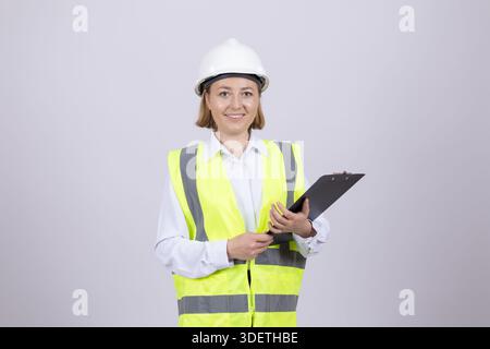 Female engineer in hardhat using digital tablet Stock Photo