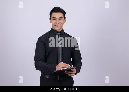 Young man in black shirt using tablet Stock Photo