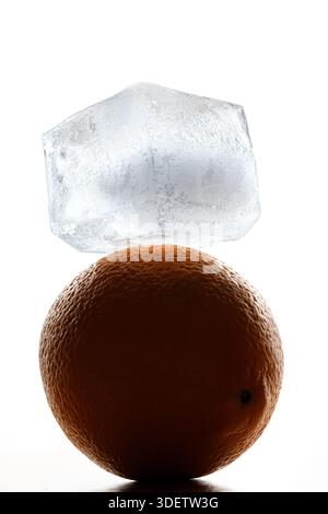 A piece of ice lies on an orange like art Stock Photo