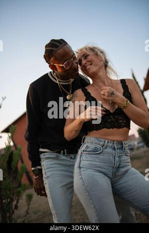 young couple dancing outside and laughing together Stock Photo