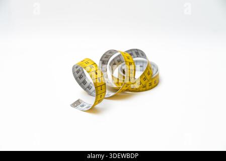 Yellow Taylor's Measuring Tape on a white background.Selective focus. Stock Photo