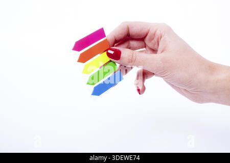 Female hand holding color tabs isolated on a white background Stock Photo