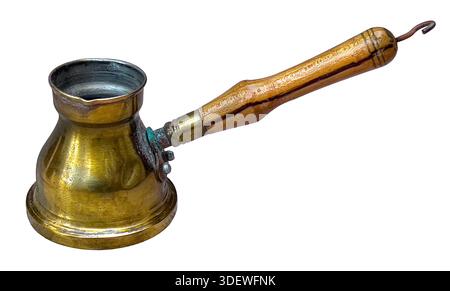 Old brass turkish coffee pot with a wooden handle, ready for preparing traditional brew Stock Photo