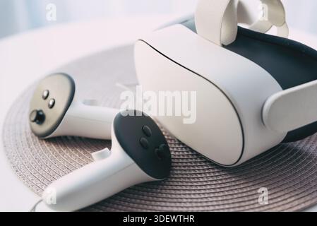 Virtual reality VR glasses with pair of controllers on the table Stock Photo