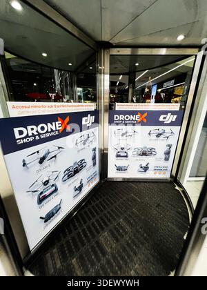 Chisinau, Moldova - November 29, 2025: Promotional DJI drone posters for drones at a glass storefront inside a mall entrance. Stock Photo