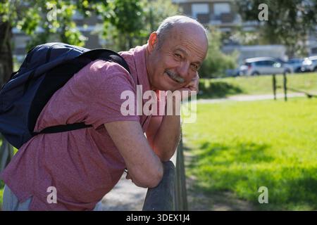 Senior pensioner relaxing outdoors, enjoying a walk and fresh air during retirement. Stock Photo