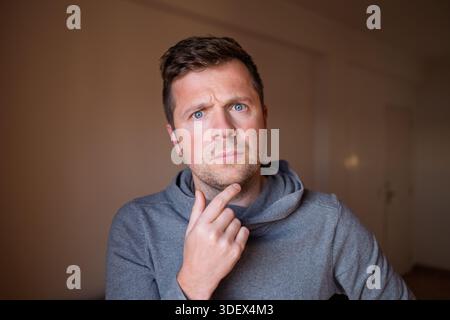 Middle Aged European Man Worried, Thinking About His Problems and Hopeless Situation Stock Photo