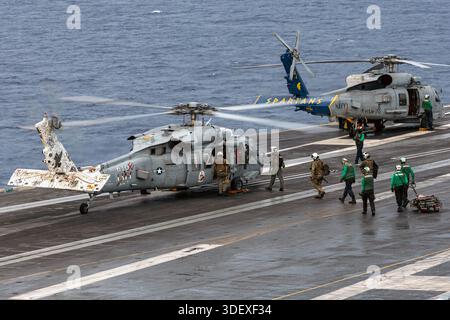 U.S. Coast Guard and Law Enforcement Tactical Team members, Sailors, and Marines board an MH-60S Sea Hawk helicopter, attached to Helicopter Sea Comba Stock Photo