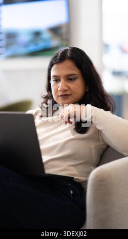 freelancer working remotely on laptop from a cafe Stock Photo