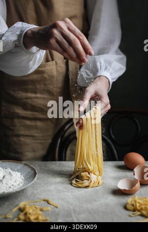 Homemade pasta making process. Rustic style. Hands in frame Stock Photo