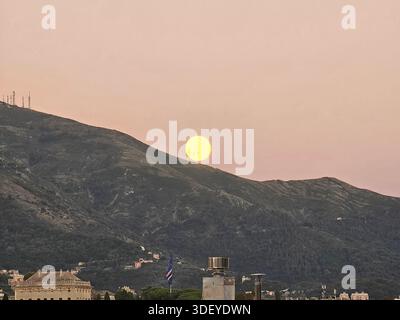 Genova, Italy - January 3, 2026: An amazing photography of the full moon over the city of Genova by night with a great clear and blue sky Stock Photo
