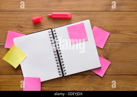 Workspace With Blank Notebook and Colorful Sticky Notes on Wooden Table for Brainstorming Ideas Stock Photo