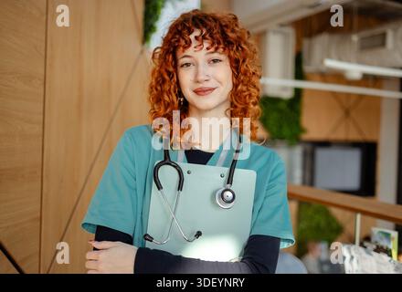 Young female nurse using smartphone on her break time Stock Photo