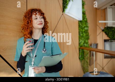 Young female nurse using smartphone on her break time Stock Photo