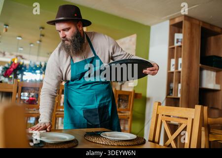Happy Barista Using Mobile Phone in a Cafe Stock Photo