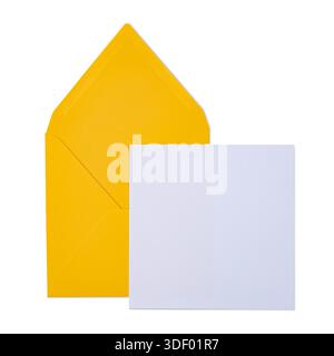 Blank white rectangular paper card sliding from an open yellow envelope, Top view, isolated on a white background. Stock Photo