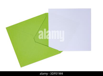 Green envelope presenting blank white card. Top view, isolated on a white background. Stock Photo