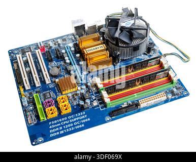 Computer main circuit board with RAM memory and CPU heat sink installed, obsolete design Stock Photo