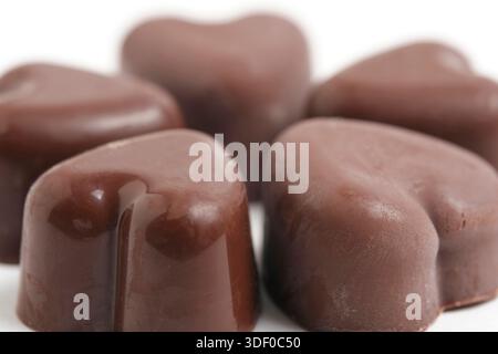 Chocolate candies in shape hearts on white background Stock Photo