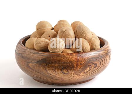 Walnuts in wooden bowl on white background. Isolated Stock Photo