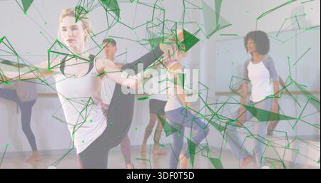 Dancing front dancer raising leg balancing in studio, white tank, leggings, barre, green overlay Stock Photo