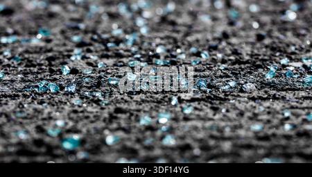 bits of broken tempered car windshield glass in the city streets Stock Photo