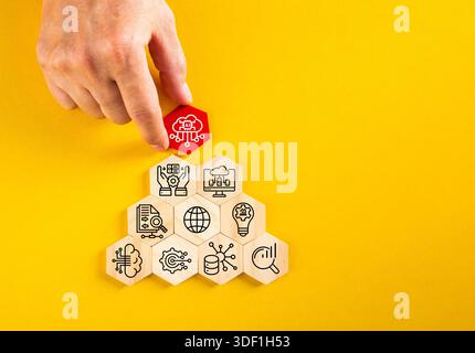 Human hand adding artificial intelligence cloud icon to a stack of technology concept hexagons Stock Photo