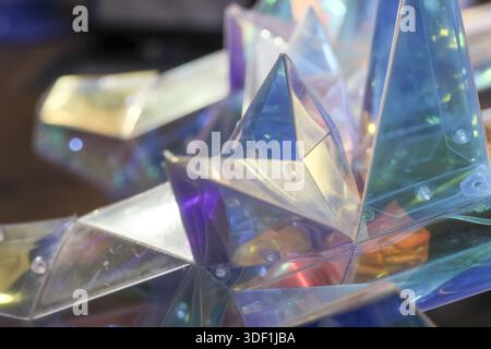 Shiny geometric glass pyramids reflecting magical iridescent light with sharp crystal prism texture and futuristic holographic pattern create abstract Stock Photo