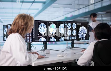 Neurologist Examining MRI Scan To Diagnose Brain Injury In Patient. Stock Photo