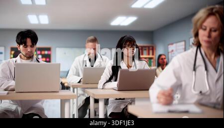 Diverse Medical Students Using Laptops To Learn Technology In University. Stock Photo