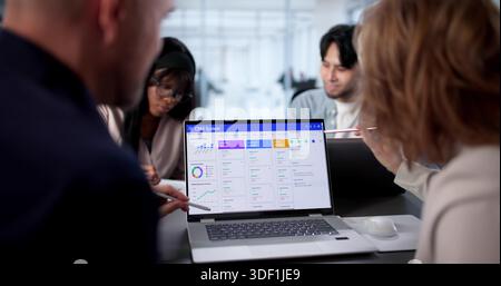 Team Of Dedicated Employees Working On CRM Software For Company. Stock Photo