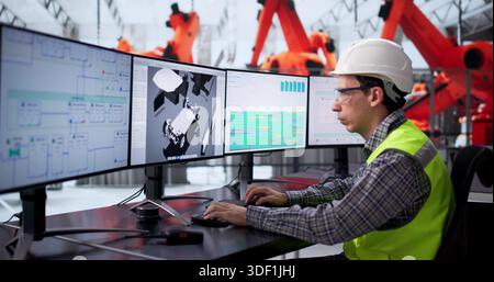 Caucasian Automotive Engineer Developing Innovative Electric Robotic Auto Assembly Line. Stock Photo