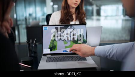 Young Engineers Using CAD Software To Design Innovative Home Renovations. Stock Photo
