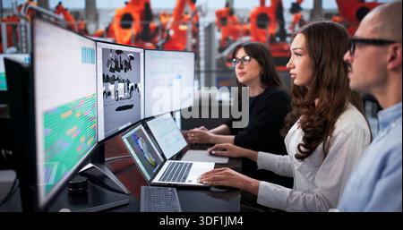 Team Of Engineers Working On 3D Car Design At Factory. Stock Photo