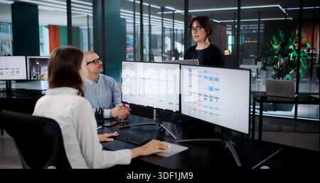Creative Team Developing User Interfaces For Online App On Computer Stock Photo