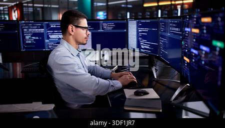 Latin Engineer Developing Code On Desktop In Modern Office Environment Stock Photo