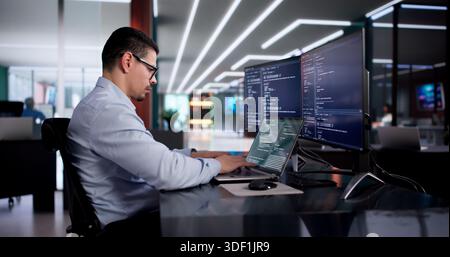 Hispanic Software Engineer Develops Program In Computer Office Workspace. Stock Photo
