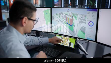Young Hispanic Man Using CAD Software To Design Virtual House. Stock Photo