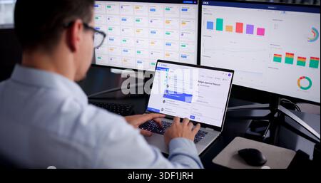 Young Hispanic Man Working On Computer, Checking Screen For Business Emails. Stock Photo