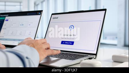 Hispanic IT Professional Uploads Secure Data To Encrypted Cloud Archive. Stock Photo